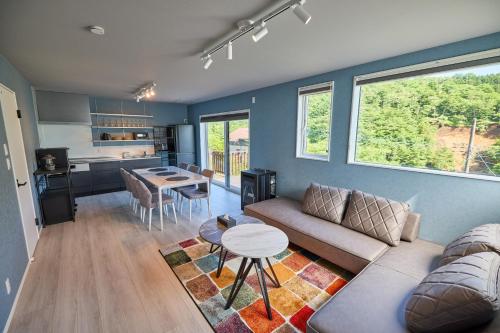 a living room with a couch and a table at COCO VILLA 山中湖 -Lake Yamanakako- in Yamanakako