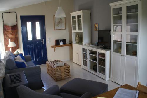 a living room with a couch and a tv at O Ioannis in Kritinía