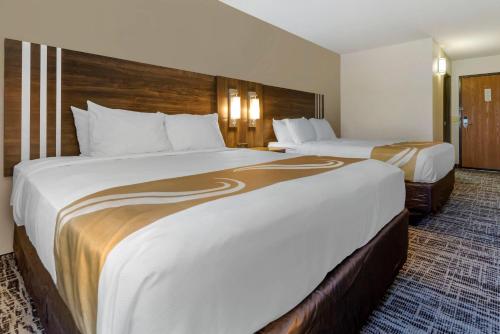a hotel room with two beds in a room at Quality Inn St Cloud West in Saint Cloud