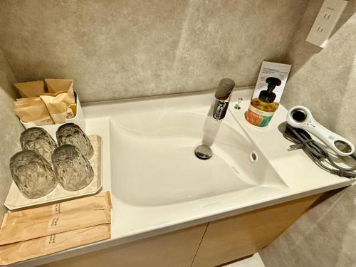 a bathroom sink with a faucet on a counter at Gouhou Garden Hotel Asakusa in Tokyo