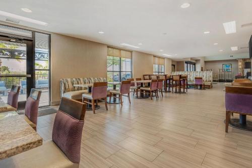 a dining room with tables and chairs and windows at Comfort Suites of Las Cruces I-25 North in Las Cruces