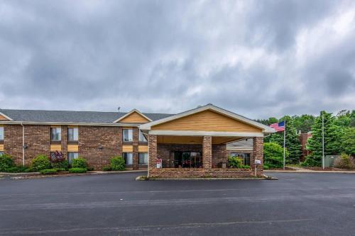 a brick building with a flag in front of it at Quality Inn Tully I-81 in Tully