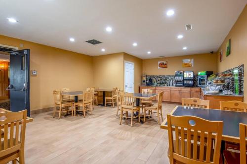 a restaurant with tables and chairs and a counter at Quality Inn Tully I-81 in Tully