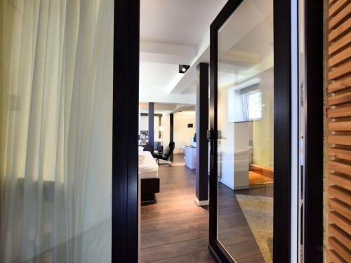 a glass door leading into a room with a bedroom at Manor house flat in Robertville in Robertville