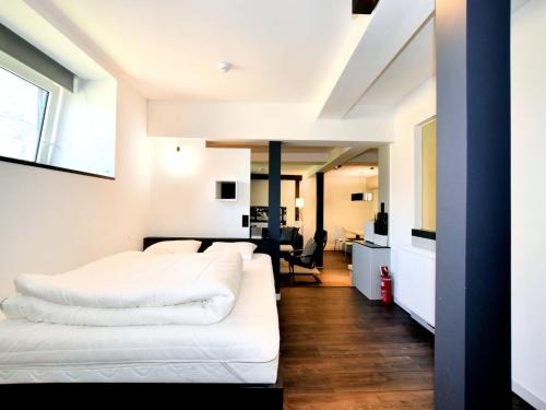 a hotel room with two beds and a desk at Manor house flat in Robertville in Robertville