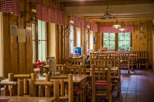 a dining room with wooden tables and chairs at Apartments Kvasničník in Demanovska Dolina