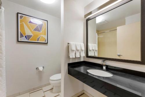 a bathroom with a sink and a mirror at Comfort Inn & Suites Akron South in Akron