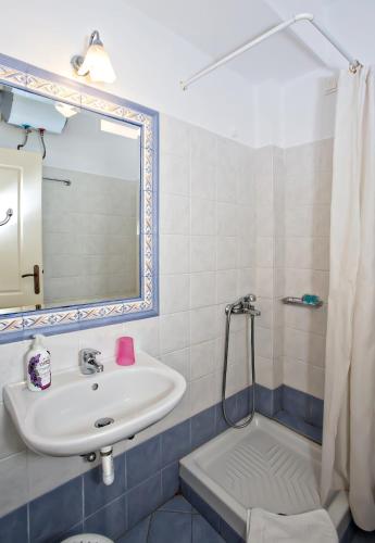 a bathroom with a sink and a shower at Tiniotissa Studios in Tinos