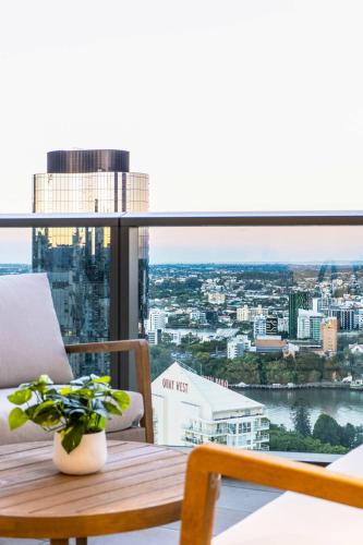 a room with a table and a view of a city at 3BR Apt in Queen's Wharf - Level 29 with city and panoramic views in Brisbane