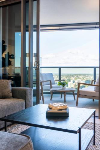 a living room with a coffee table and a view at 3BR Apt in Queen's Wharf - Level 29 with city and panoramic views in Brisbane