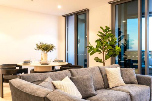 a living room with a couch and a table at 3BR Apt in Queen's Wharf - Level 29 with city and panoramic views in Brisbane