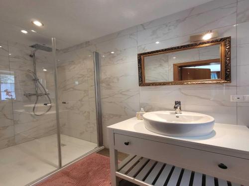 a white bathroom with a sink and a shower at Apartment in Feld am See by Brennsee Lake in Feld am See