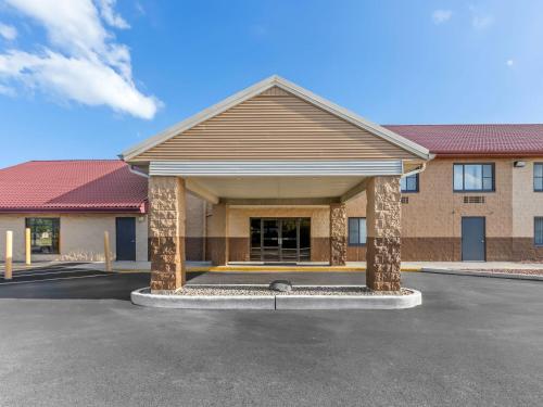 a building with a parking lot in front of it at Super 8 by Wyndham Sturtevant Racine in Sturtevant