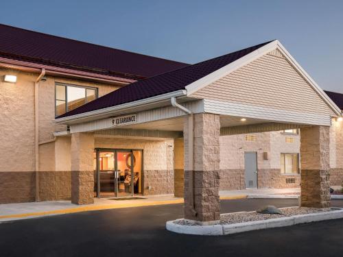 a large brick building with a garage at Super 8 by Wyndham Sturtevant Racine in Sturtevant