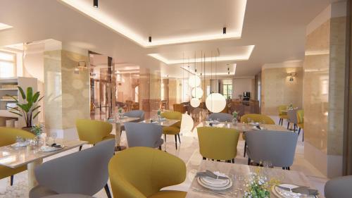 a restaurant with tables and chairs in a room at Meliá São João da Madeira in São João da Madeira