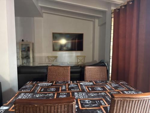 a dining room table with two chairs and a table with a blanket on it at Villa con Piscina climatizada in Sanlúcar de Barrameda