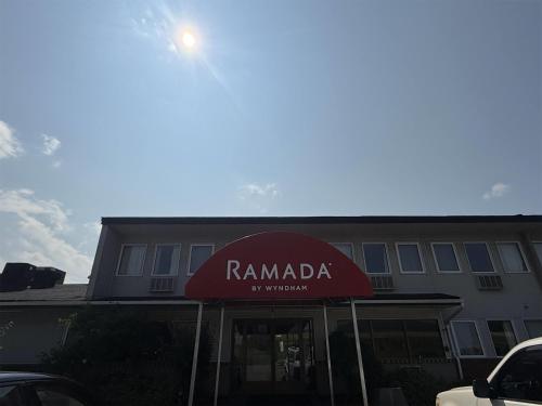 a building with a red awning in front of a building at Ramada by Wyndham Florenceville in Florenceville