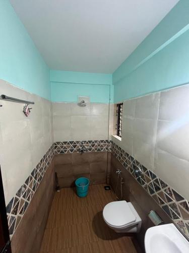 a bathroom with a toilet and a sink and a tub at The Boss House in Arambol