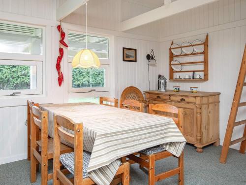 a dining room with a table and chairs at 4 person holiday home in Præstø in Præstø