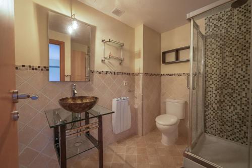 a bathroom with a sink and a toilet and a shower at 1692m Valdelinares in Valdelinares