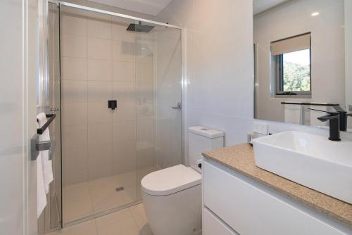 a bathroom with a shower and a toilet and a sink at Ohana A - WIFI, 10 minutes to the cafe strip in Margaret River Town