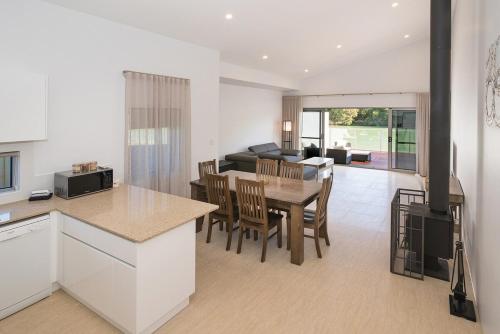 a kitchen and living room with a table and chairs at Ohana A - WIFI, 10 minutes to the cafe strip in Margaret River Town