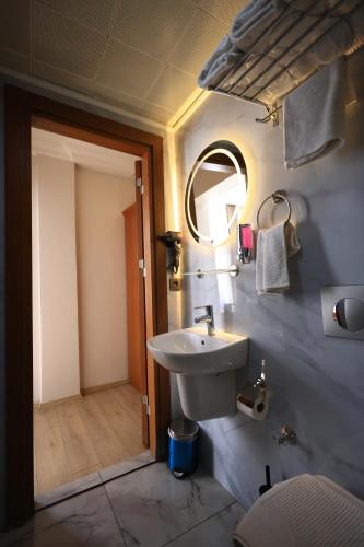 a bathroom with a sink and a mirror at New House Hotel in Istanbul
