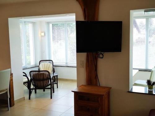 a living room with a flat screen tv on the wall at Holiday home Anna Comfortable Vacation Home in Faak am See