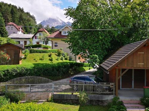 a car parked in front of a house with a fence at Holiday home Anna Comfortable Vacation Home in Faak am See