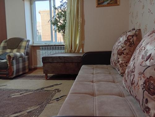 a living room with a couch and a window at Anush in Sisian