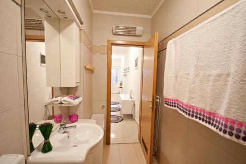 a bathroom with a sink and a toilet at Adela Apartments in Dramalj