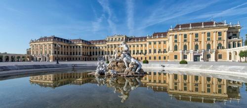 a building with a fountain in front of a building at Stylish Designer Apartment at the Center of Vienna Naschmarkt in Vienna