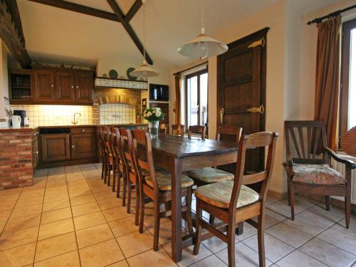a kitchen with a wooden table and chairs at Cozy Cottage, Basse-Bodeux in Trois-Ponts