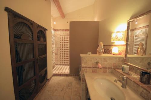 a bathroom with a tub and a sink and a shower at Mas Loisonville - Demeure d'exception & Spa en Drôme Provençale in Grillon