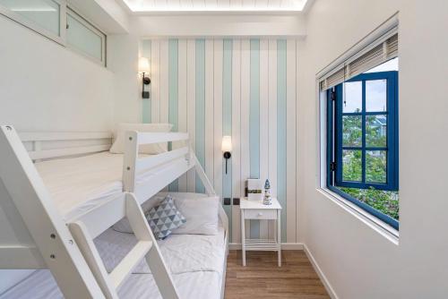 a small room with a bunk bed and a window at Sandy Villa in Phan Thiet