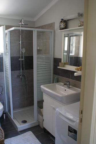 a bathroom with a shower and a sink at O Ioannis in Kritinía