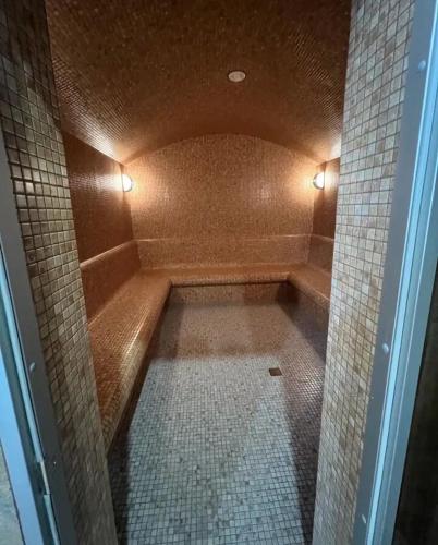 a bathroom with a shower with a tiled floor at New Alvina 44 in Tsaghkadzor