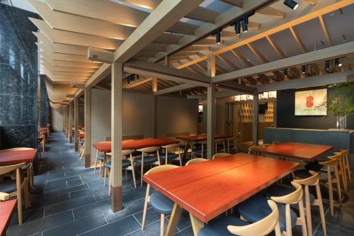 a row of tables and chairs in a restaurant at Mitsui Garden Hotel Fukuoka Gion in Fukuoka