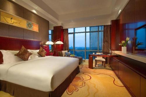 a bedroom with a large bed and a large window at Xi'an Airport Hotel in Xi'an