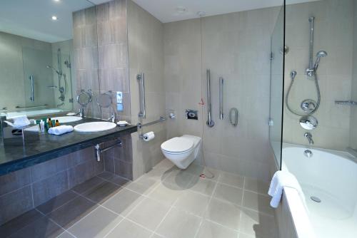a bathroom with a toilet and a sink and a shower at The Manchester Deansgate Hotel, by IHG in Manchester