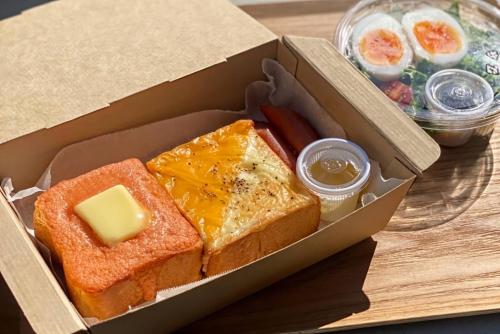 a box of bread and butter and other food on a table at &HOTEL HAKATA in Fukuoka