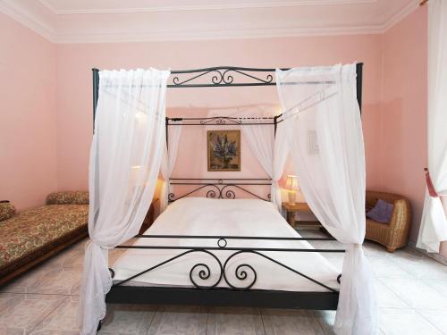 a bedroom with a canopy bed with white curtains at Triestewitz Hideaway in Saxony in Arzberg