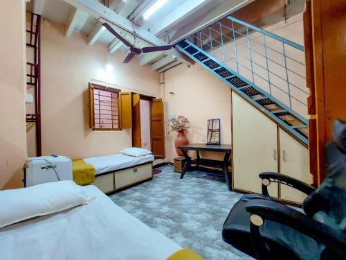 a hospital room with two beds and a staircase at Shravan Homestay in Kolhapur