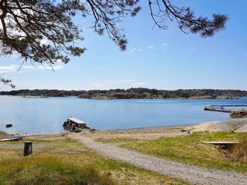 a boat sitting on the shore of a lake at 6 person holiday home in STRÖMSTAD-By Traum in Strömstad