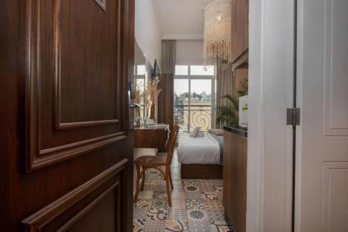 a room with a door and a bedroom with a bed at Mar Mikhael Studios in Beirut