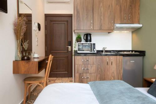a small kitchen with a bed and a microwave at Mar Mikhael Studios in Beirut