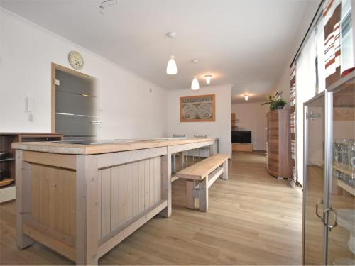 a large kitchen with a counter and a bench at Bodenwöhr Lakeside Gem in Bodenwöhr