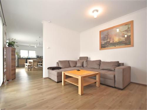 a living room with a couch and a table at Bodenwöhr Lakeside Gem in Bodenwöhr