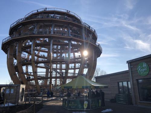 a large ferris wheel in front of a building at Bodenwöhr Lakeside Gem in Bodenwöhr