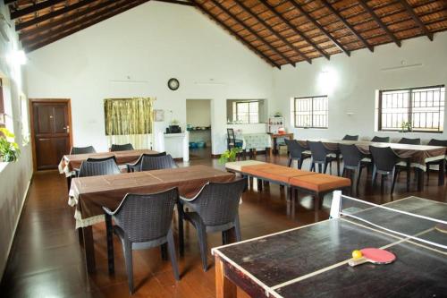 a dining room with tables and chairs in a room at The Nest bettathur, Coorg in Madikeri